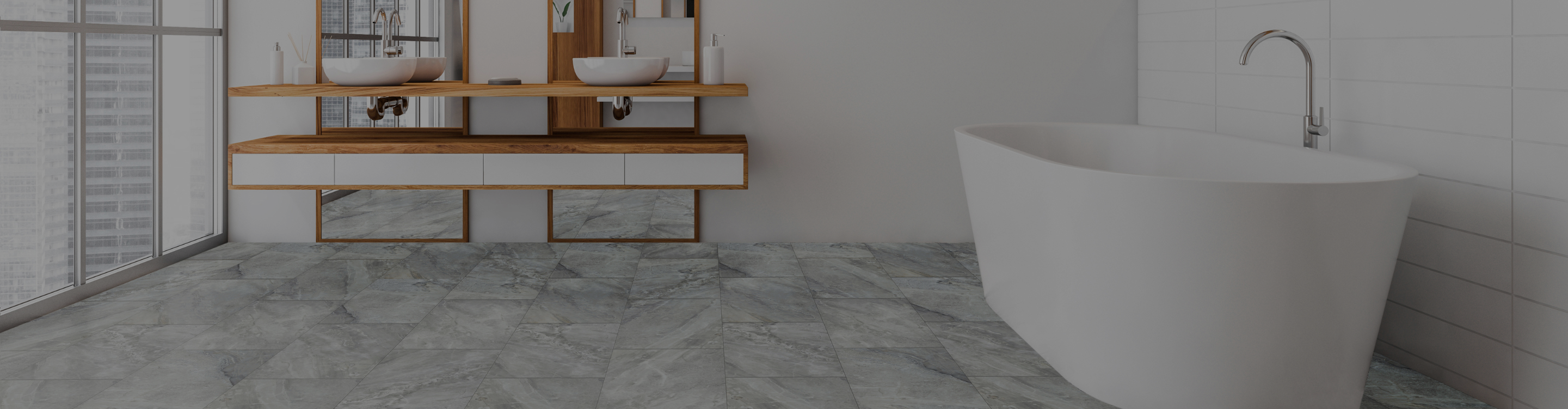 Bathroom with freestanding tub, floating vanity, and gray tile flooring